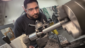 Image showing a bolt being roughly shaped on an engine lathe.